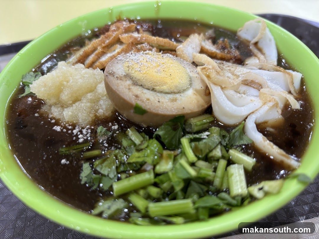Bowl of Noodle Soup with Halved Egg and Vegetables