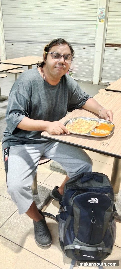 Person with food tray and backpack