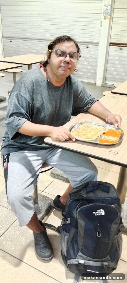 Person with food tray and backpack