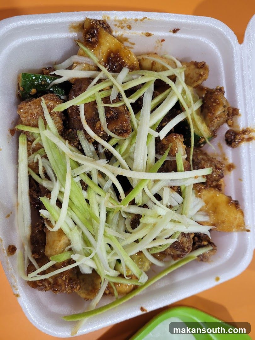 Stir-fried dish with shredded vegetables in a takeout container