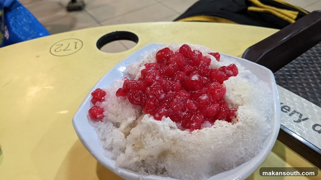 Bowl of shaved ice with red fruit topping