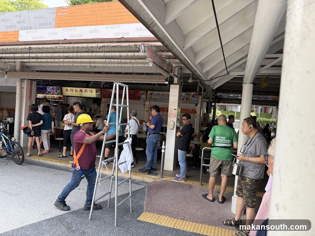 Food stall area with workers and customers