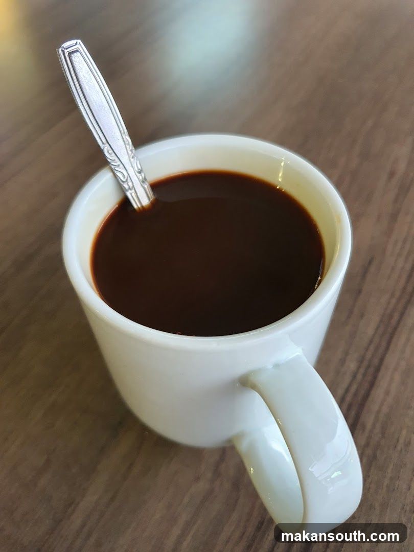 White Cup of Coffee with Spoon