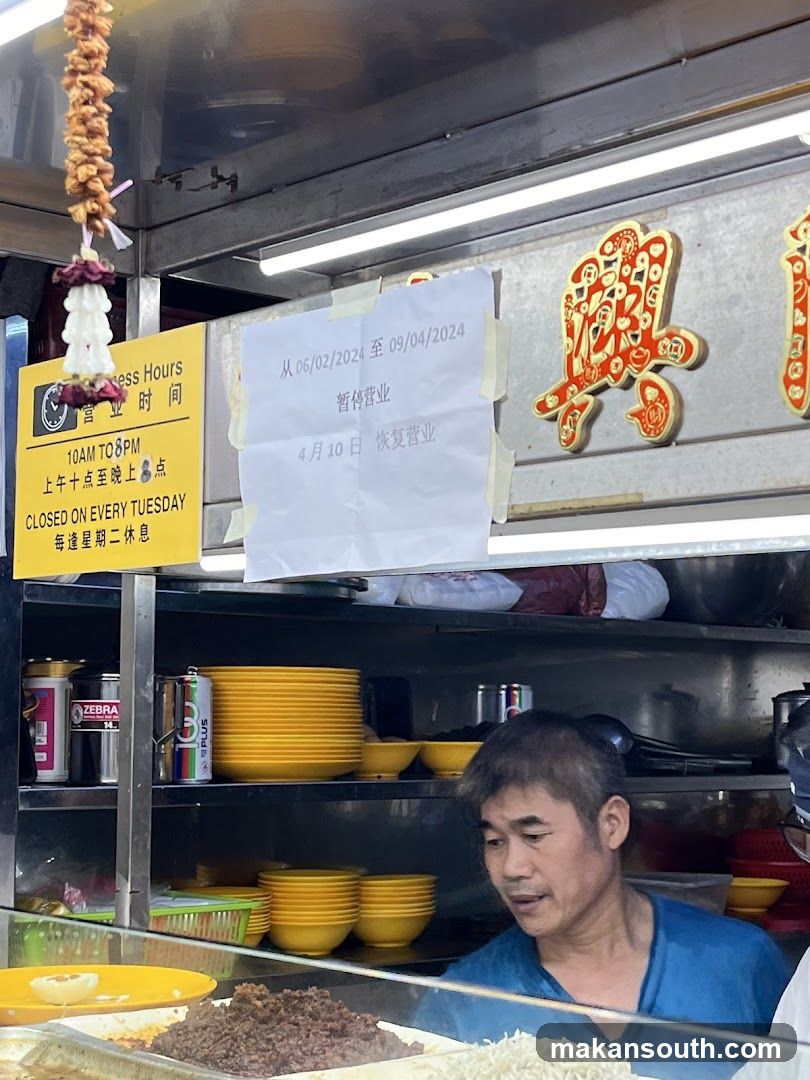 Food Stall Interior with Staff and Signage