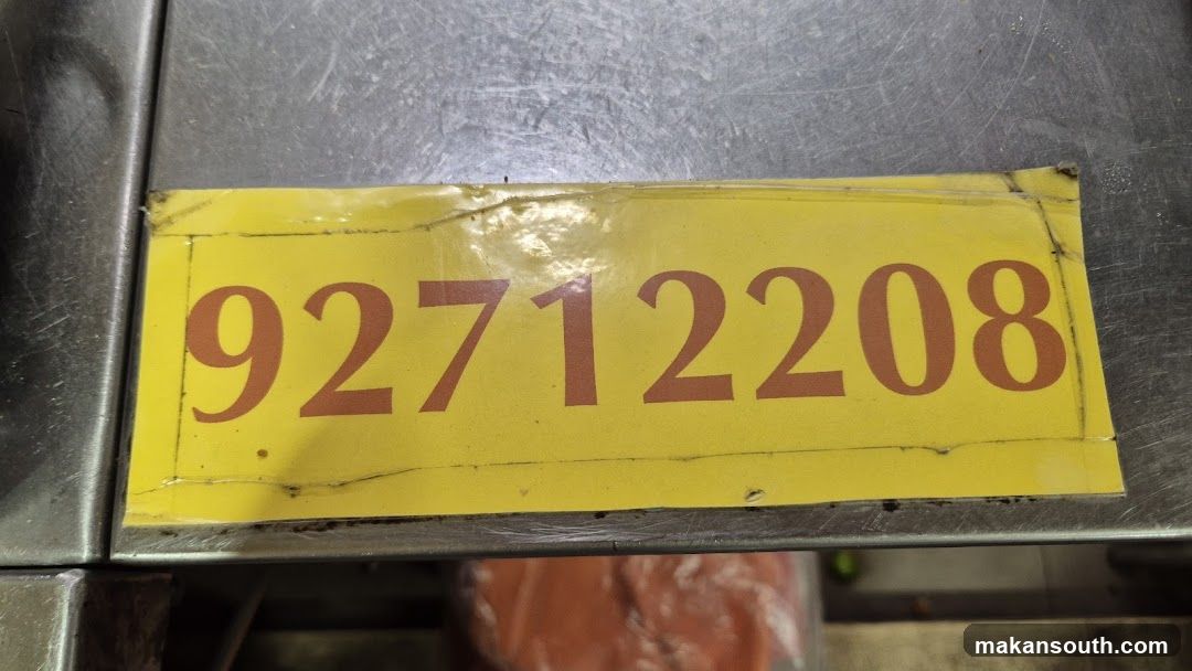 Yellow Numbered Label on Stainless Steel Surface