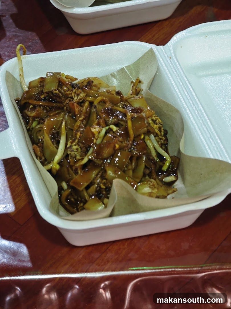 Nasi Lemak or similar dish in takeaway container
