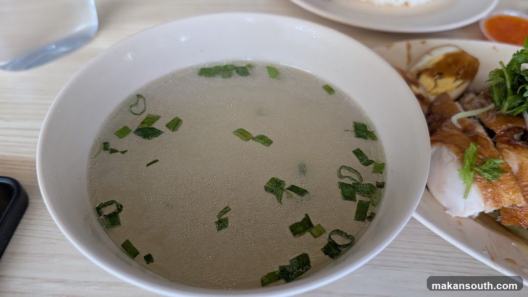 Bowl of Soup with Green Onions and Plate of Chicken