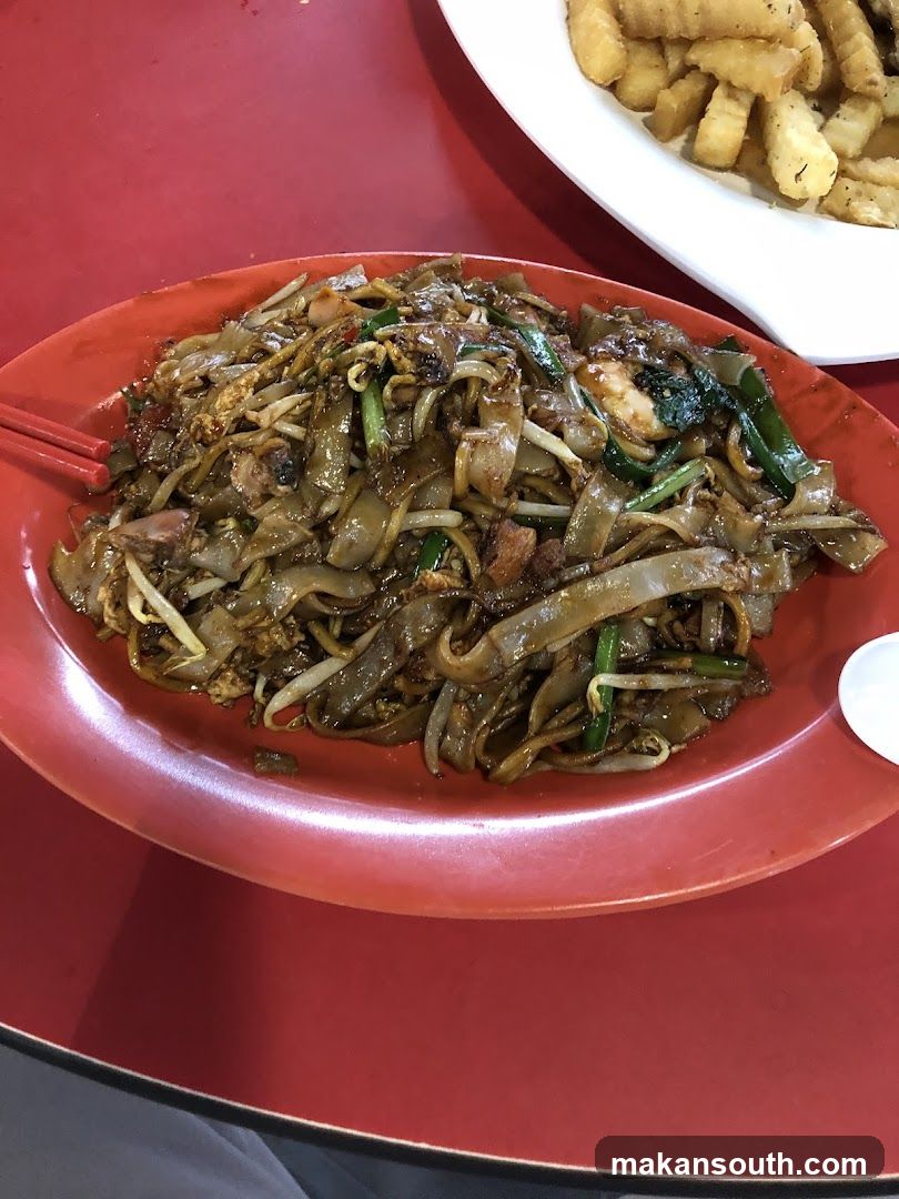 Plate of stir-fried noodles with vegetables and meat