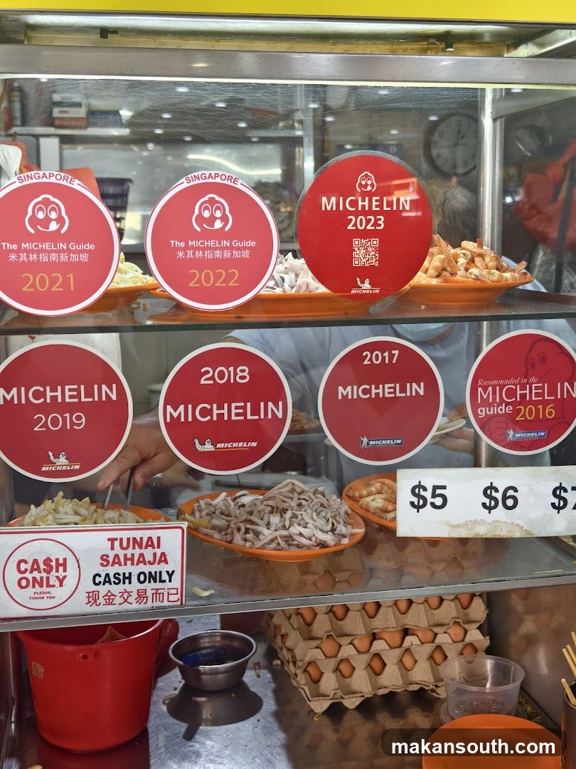 Food stall display with Michelin awards