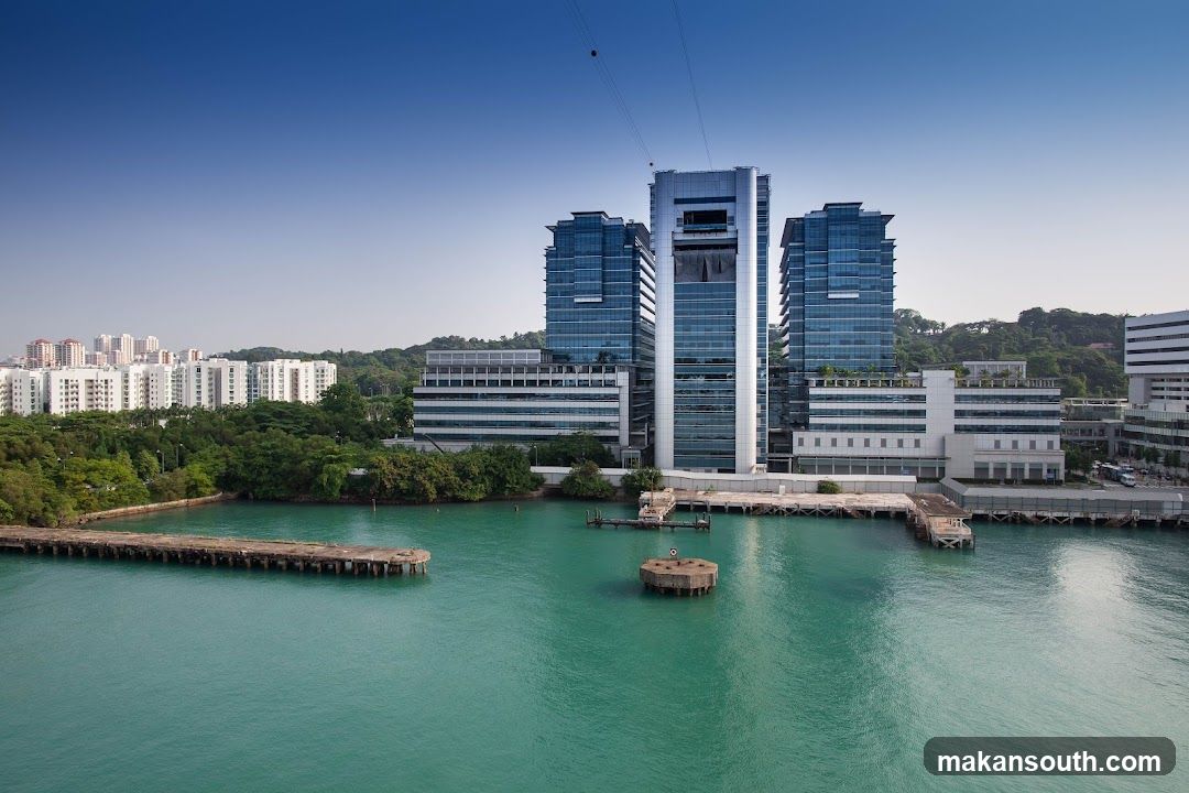 Modern waterfront complex with glass towers and piers