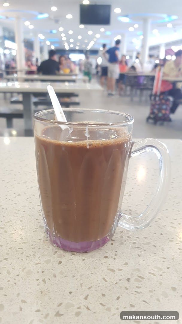 Coffee in a glass mug at a food court