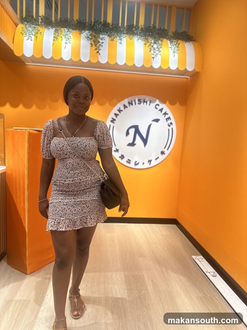 Woman in floral dress at Nakanishi Cakes interior