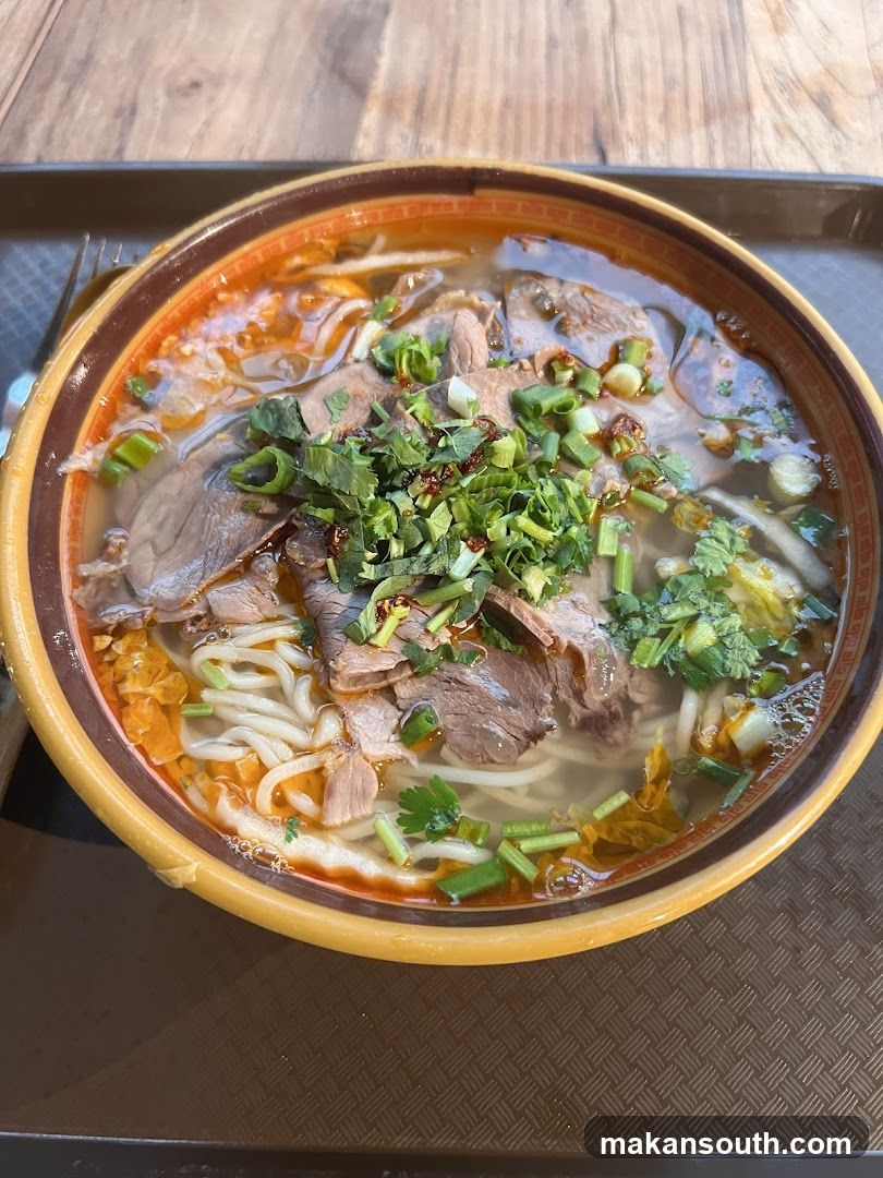 Bowl of Noodle Soup with Meat and Greens