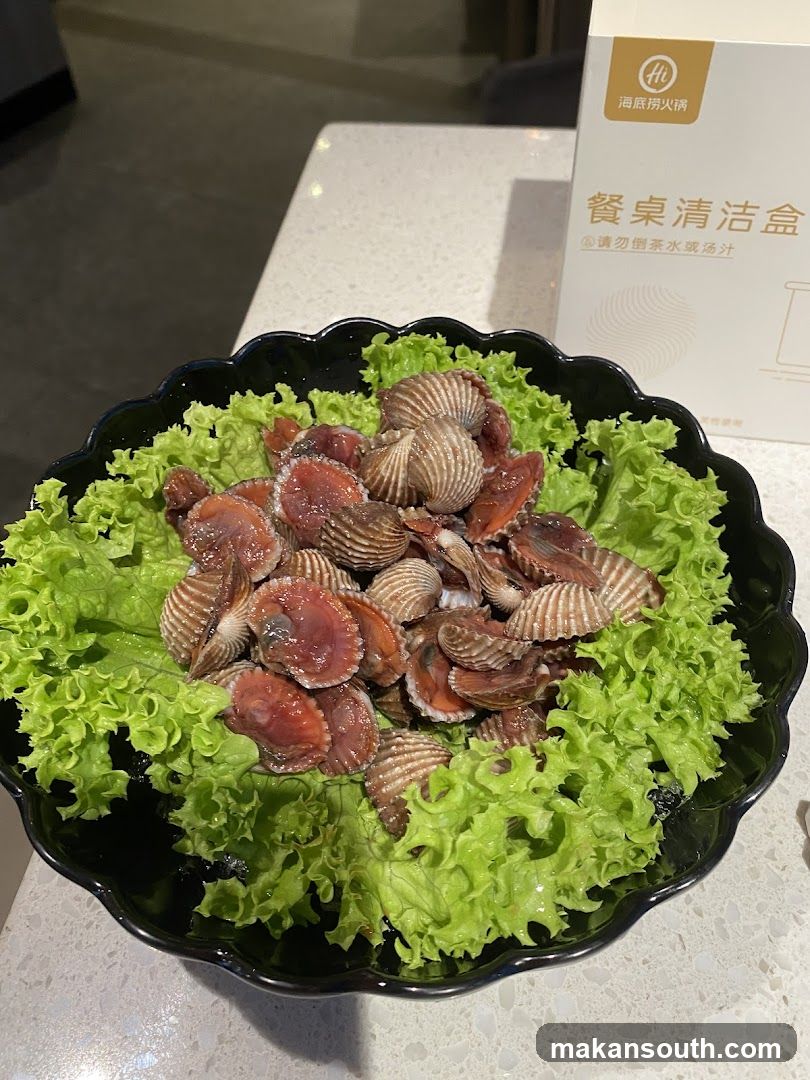 Bowl of Clams on Lettuce with Cleaning Box in Background