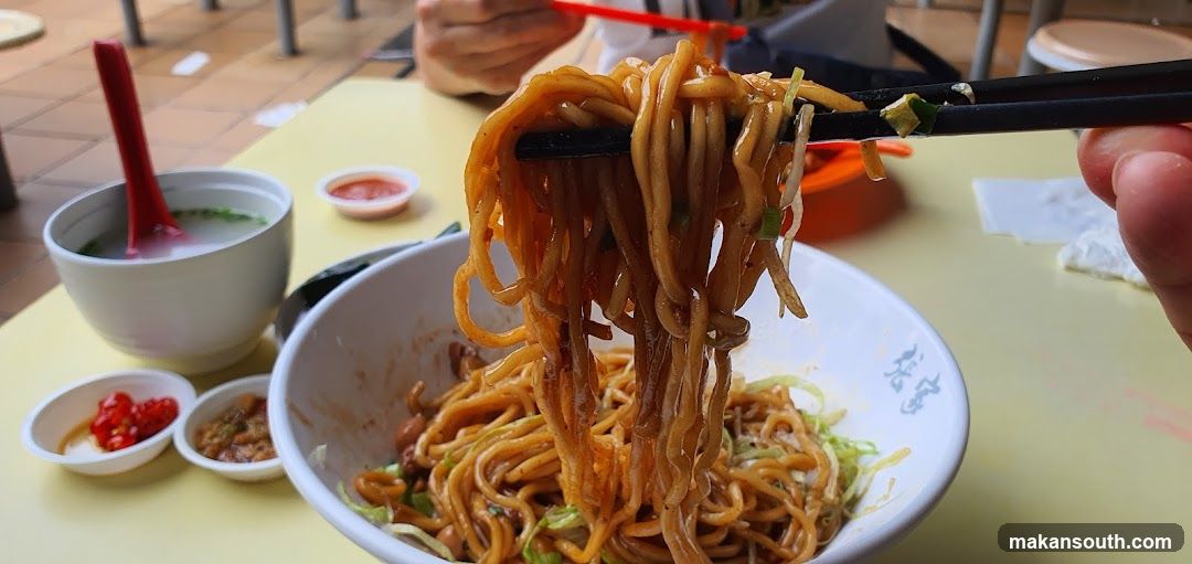 Noodles being lifted with chopsticks