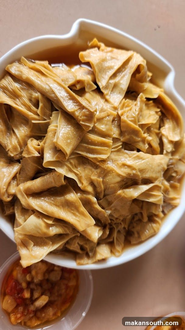 Bowl of braised tofu skin with dipping sauce