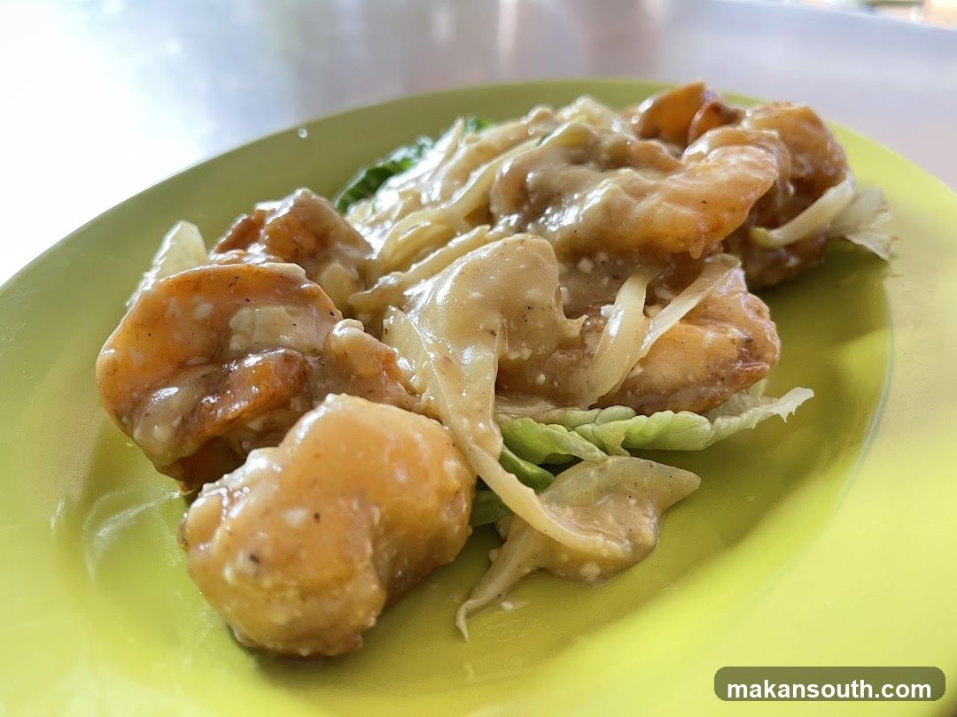 Sauce-covered shrimp dish on a green plate
