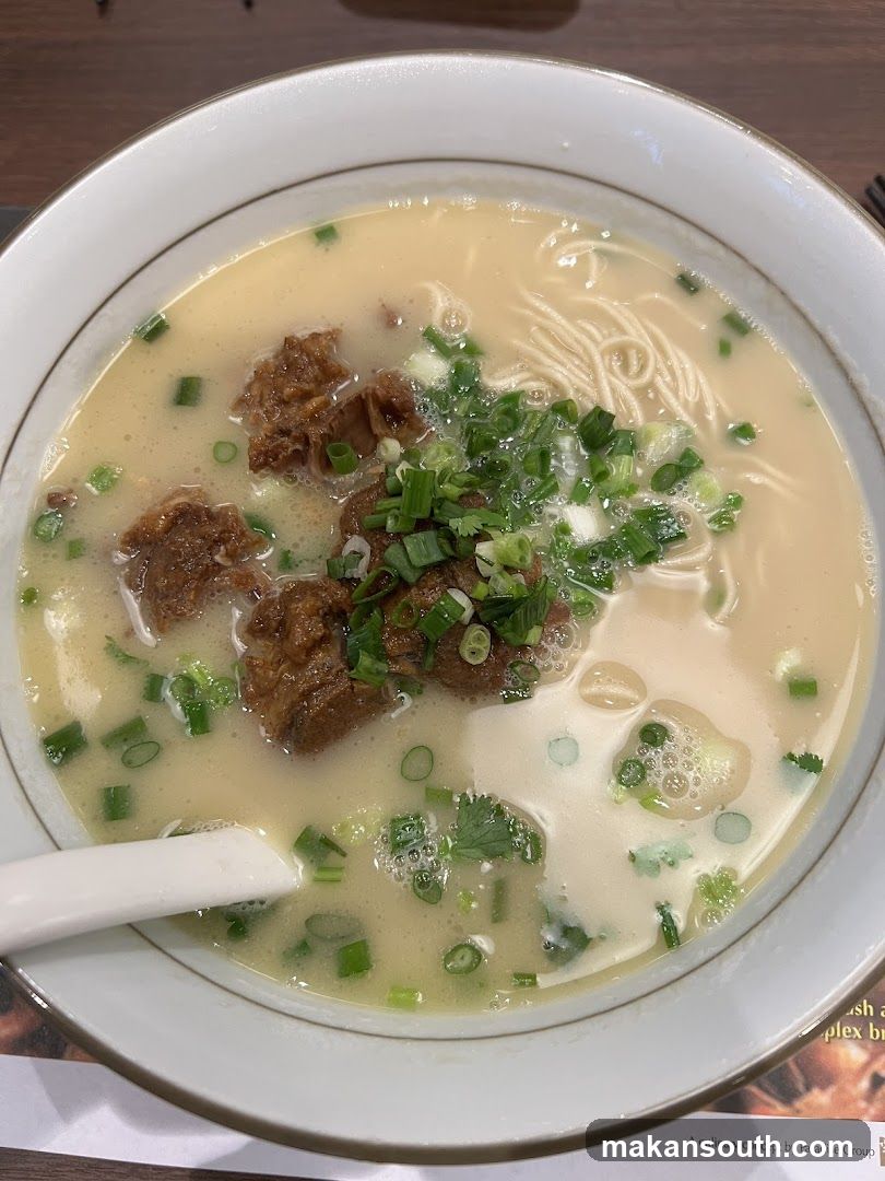 Bowl of Noodle Soup with Meat and Green Onions