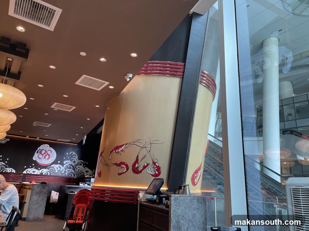 Interior of a restaurant with large decorative shrimp mural