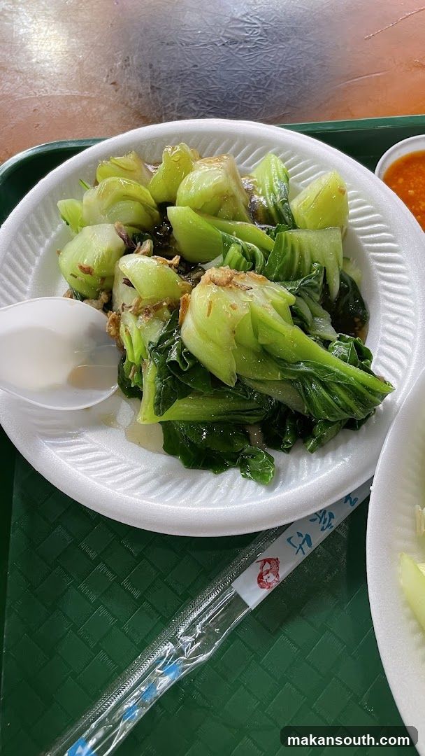 Bowl of stir-fried bok choy with soy sauce and garlic