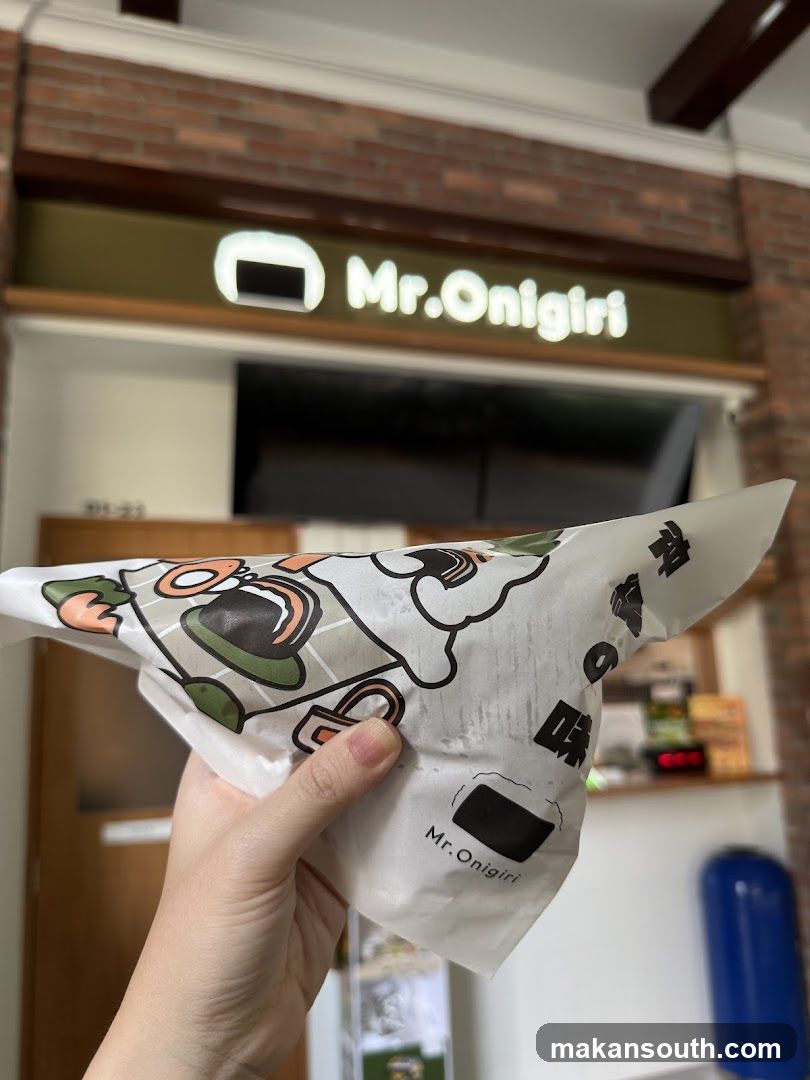 Onigiri Wrap Held in Front of Store
