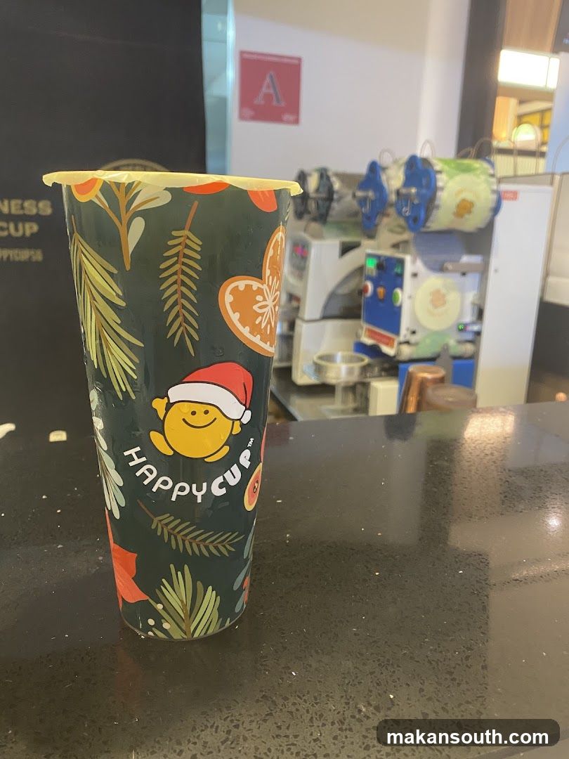 Happy Cup Christmas-themed cup on counter