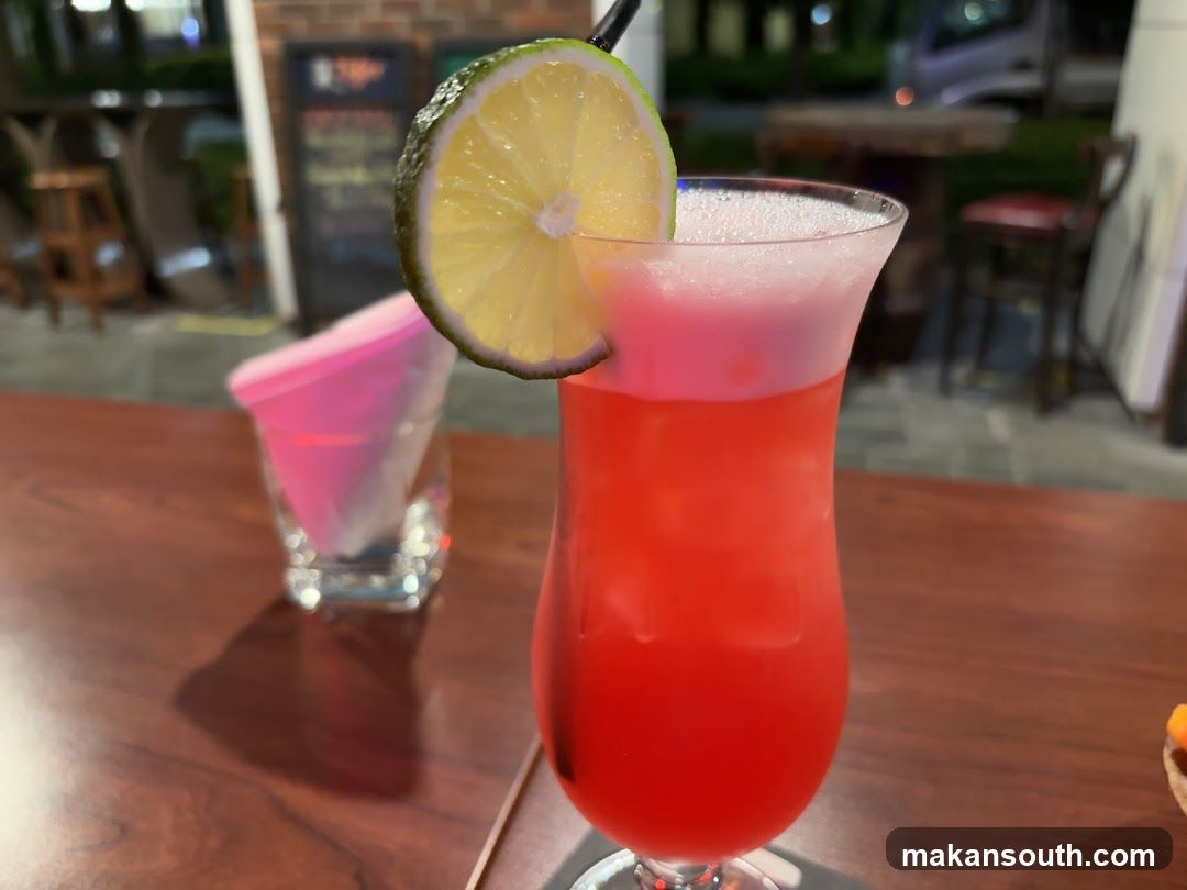 Red Cocktail with Lime Garnish