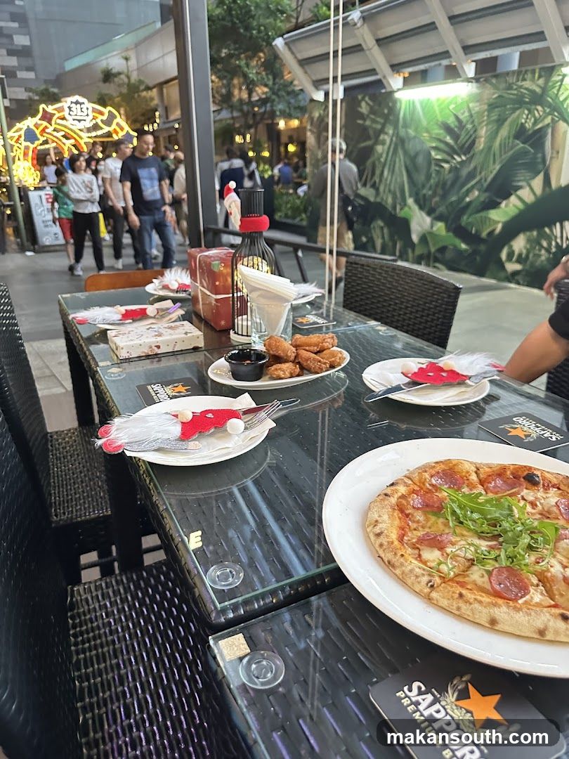 Outdoor Dining Table with Pizza and Fried Chicken