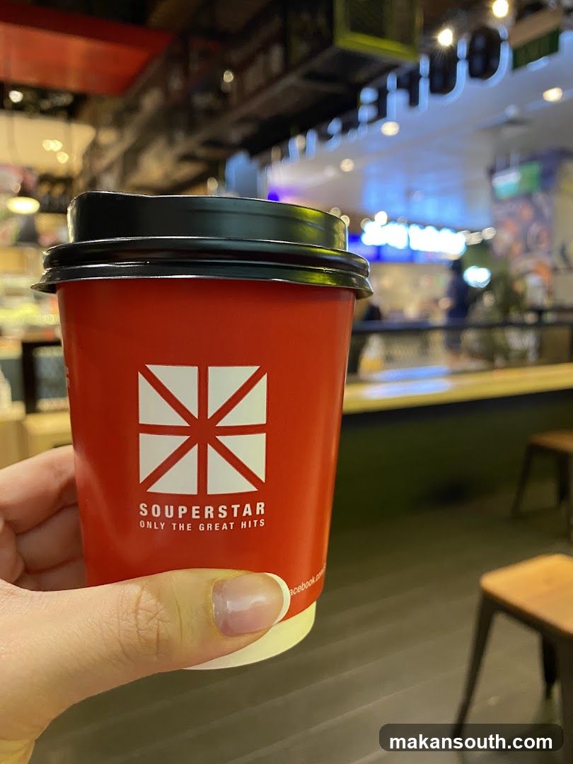 Red cup held in hand at food court