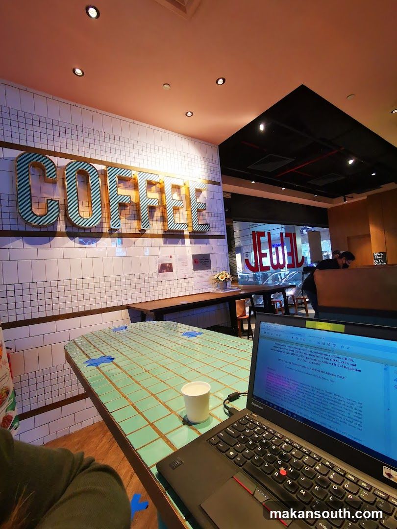 Coffee Shop Interior with Laptop and Signage