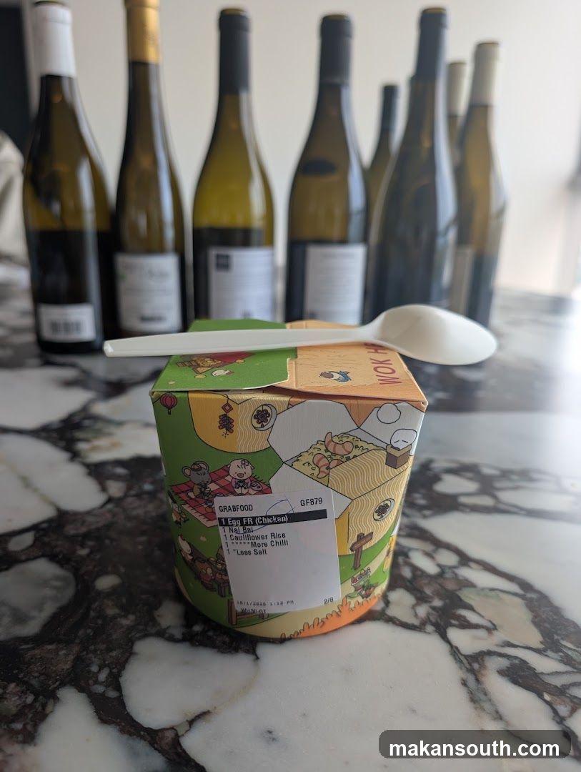 Food container with wine bottles in background