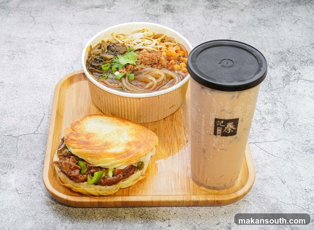 A meal set with noodles, sandwich and drink