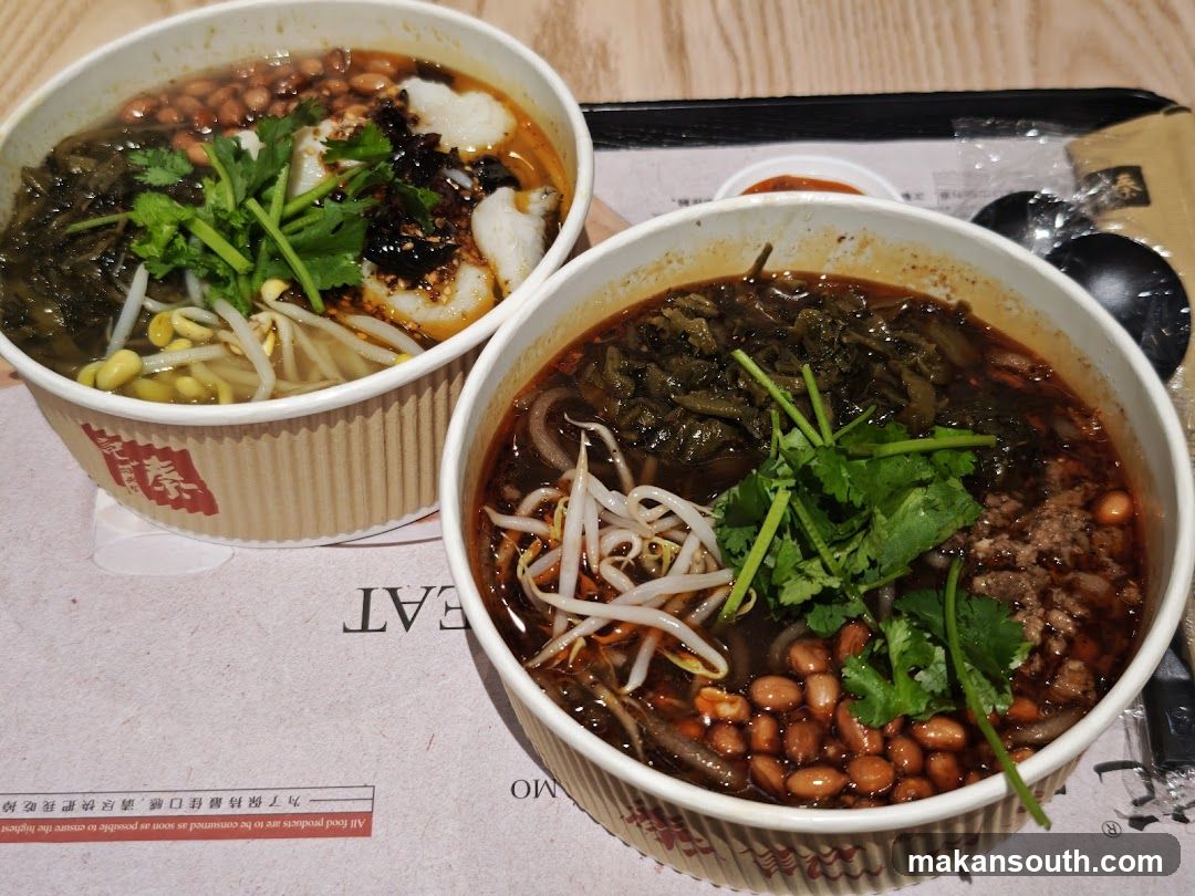 Two bowls of spicy noodle soup with toppings