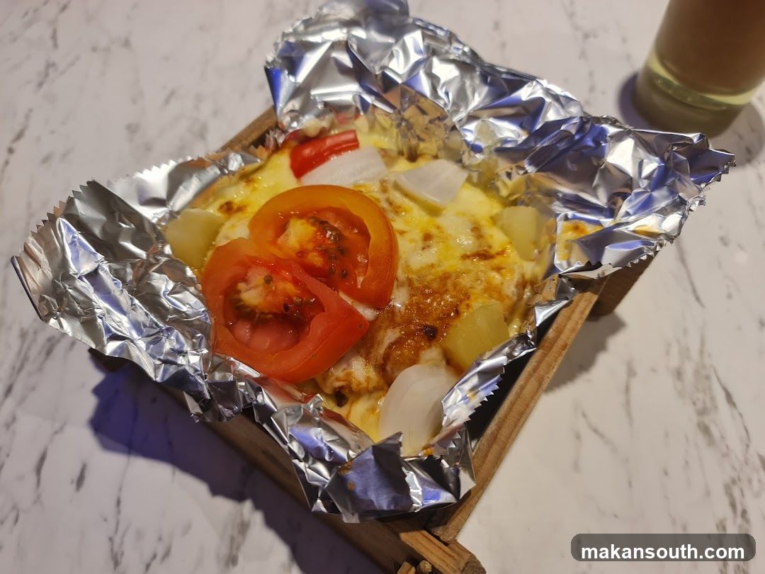 Foil-Wrapped Breakfast Dish with Tomatoes and Onions