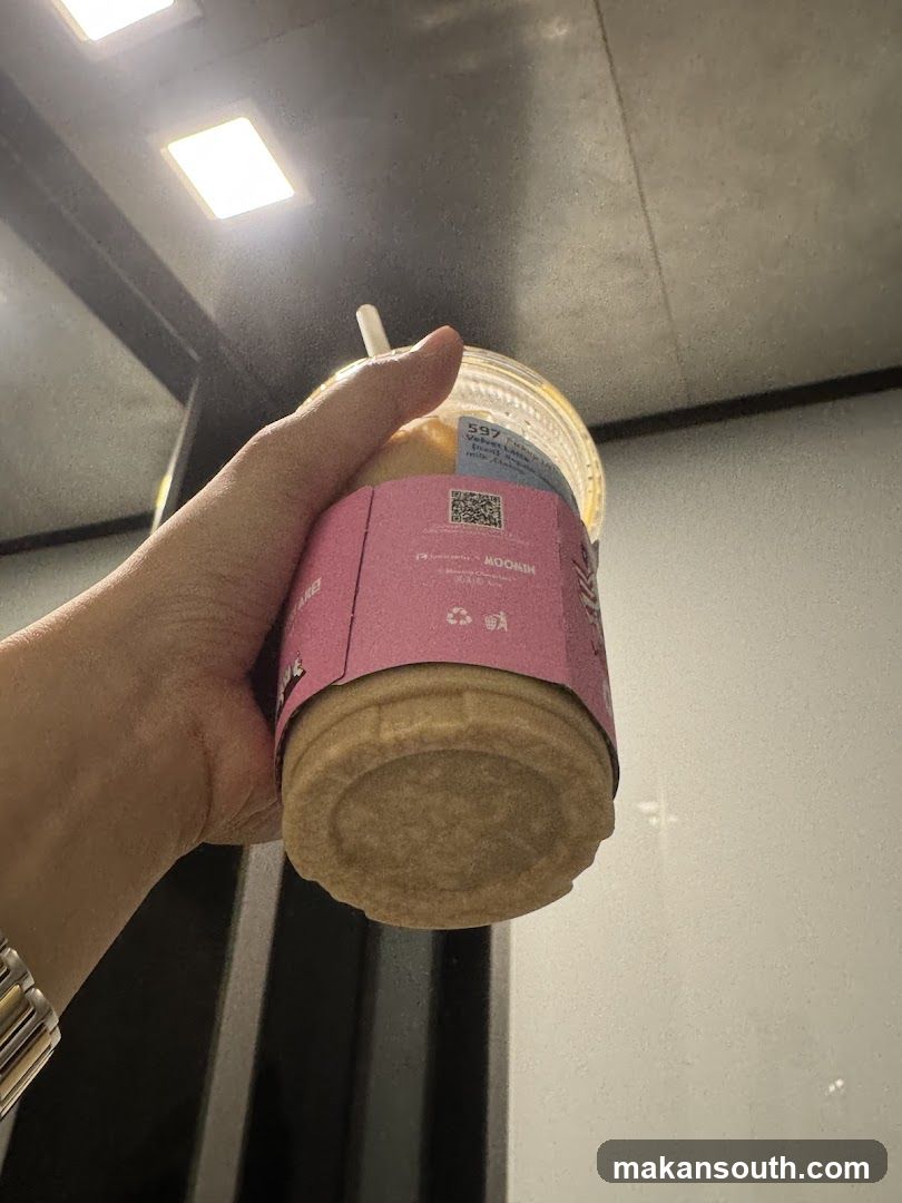 Hand holding iced coffee drink