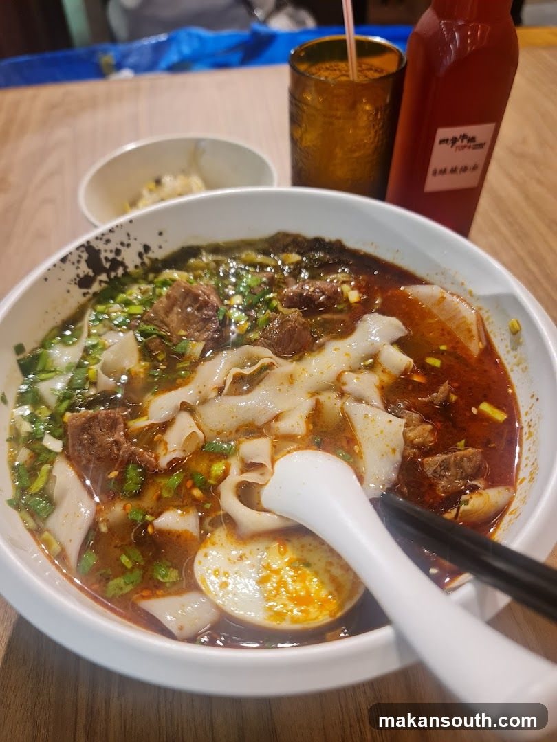 Bowl of Noodles with Broth and Condiments