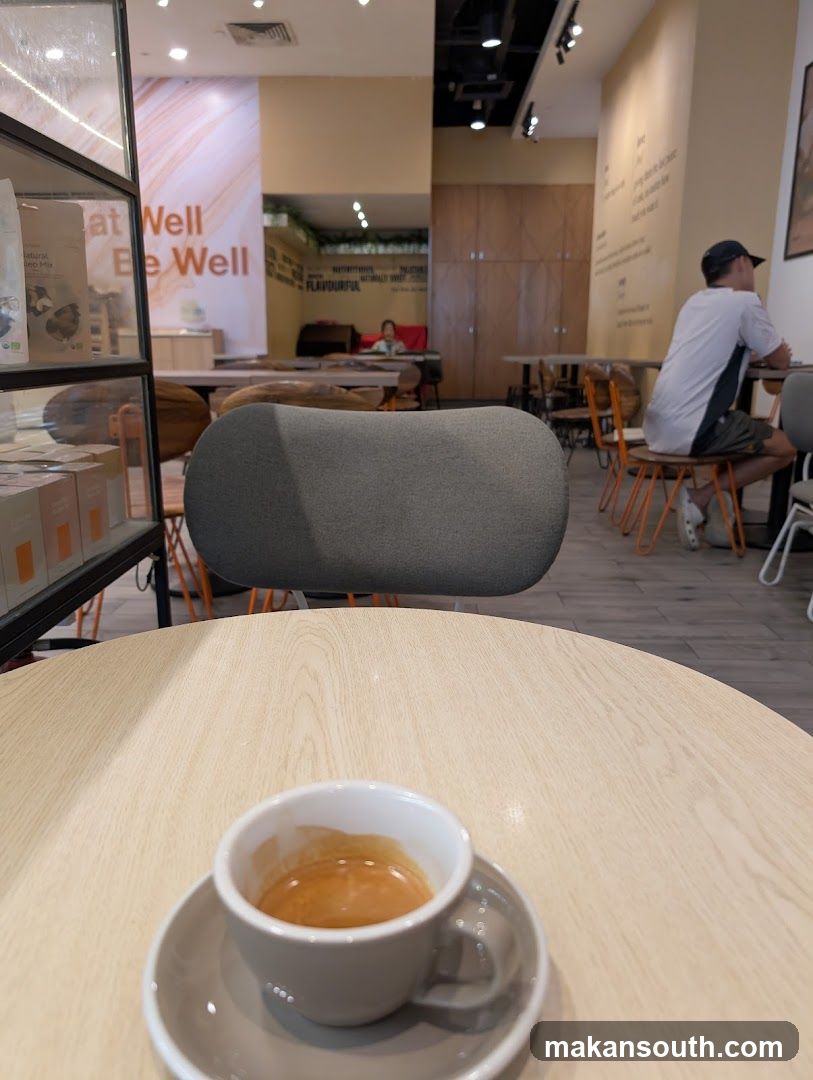 Coffee Shop Interior with Espresso Cup in Foreground