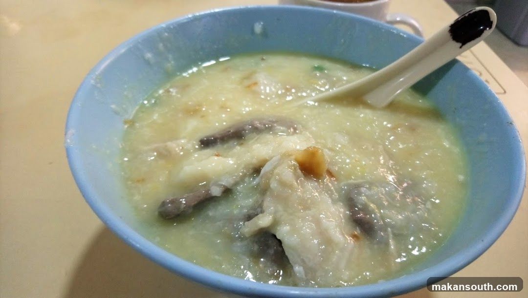 Bowl of congee with meat and vegetables