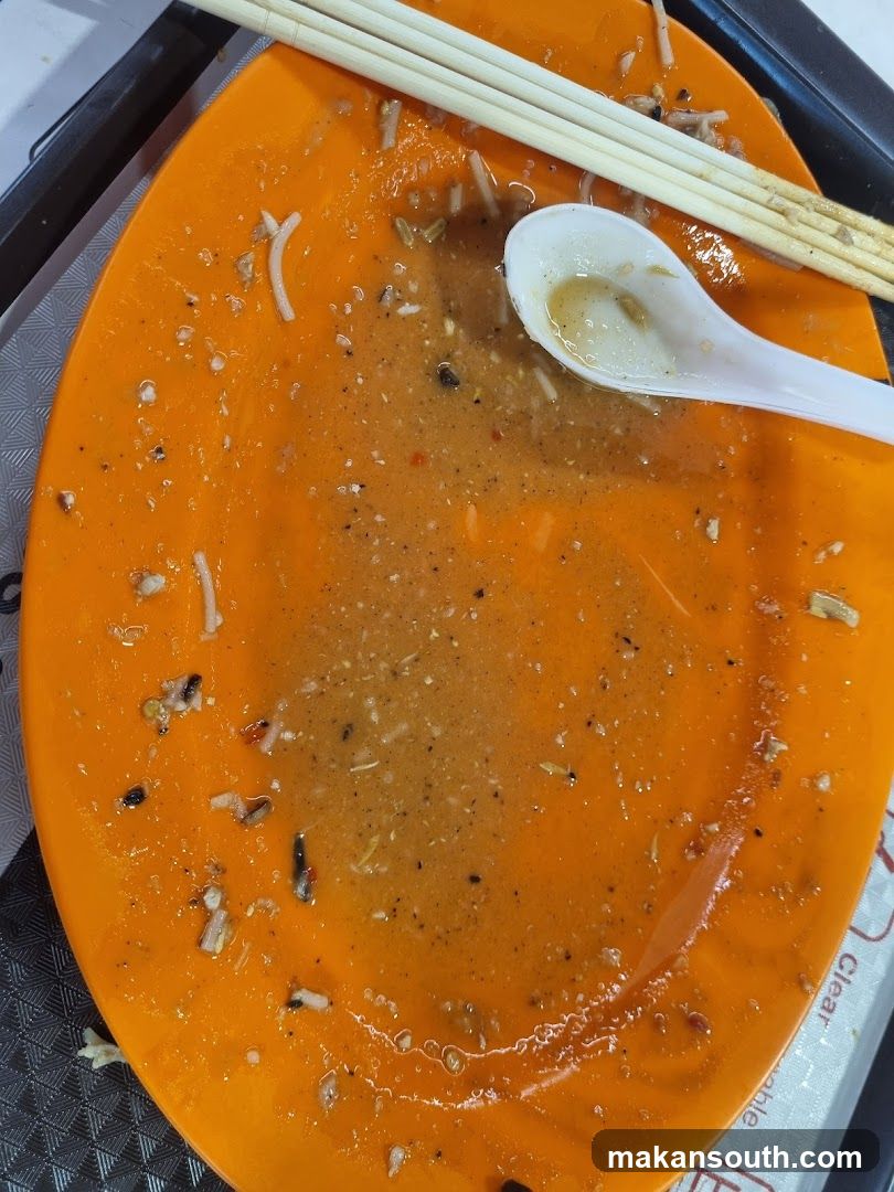 Empty Orange Plate with Chopsticks and Spoon