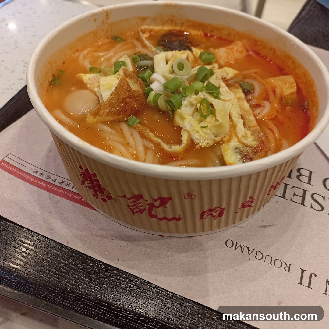 Bowl of Noodle Soup with Egg and Scallions