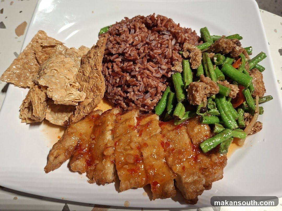 Plate of Food with Brown Rice, Green Beans, and Fried Items