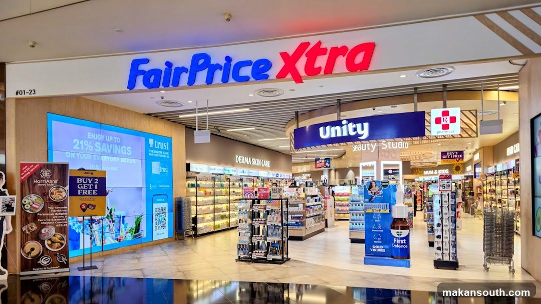 Entrance to FairPrice Xta with visible signage above, featuring promotional displays inside including Unity pharmacy section.