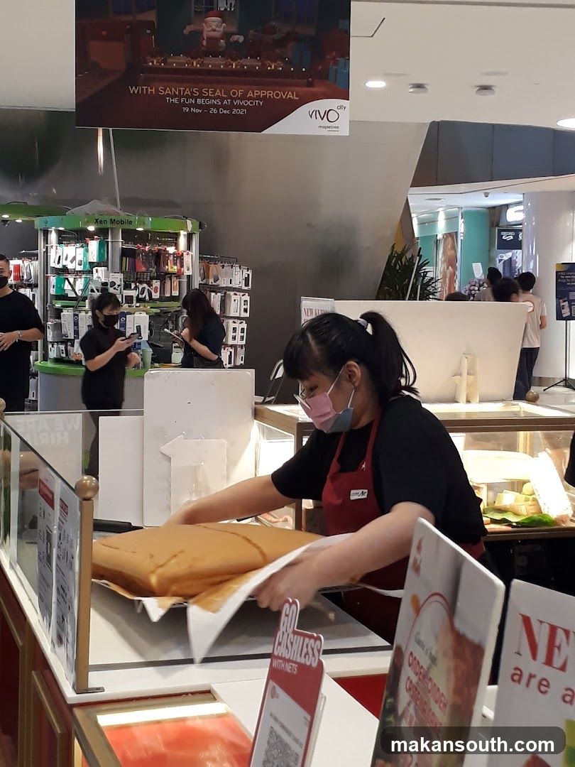 Food stall interior with staff serving cake