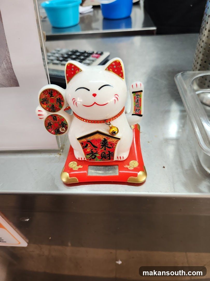 Maneki-neko figurine on counter