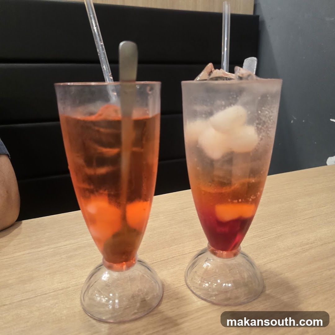 Two glasses of mixed drinks on a table