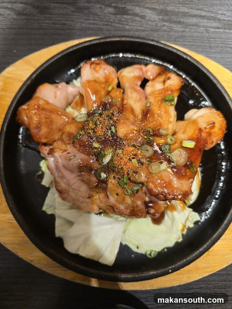 Sizzling Meat Dish with Cabbage and Seasoning