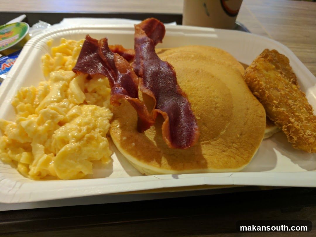 Breakfast Meal with Pancakes, Bacon, Scrambled Eggs and Chicken Strip