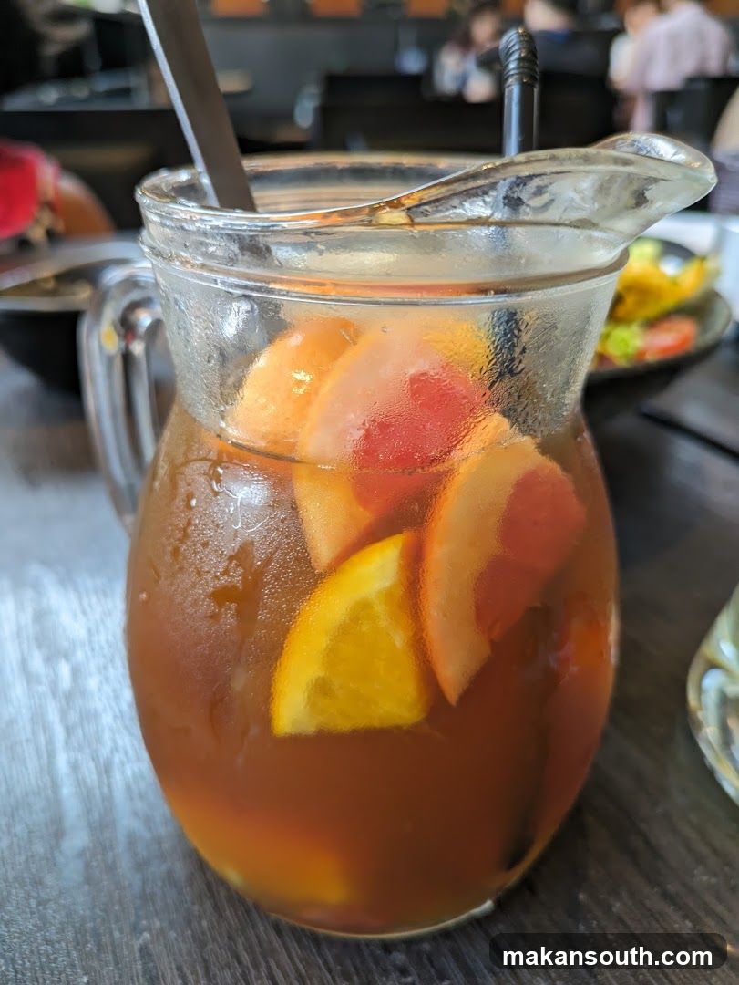 Fruit-infused iced tea in a glass pitcher