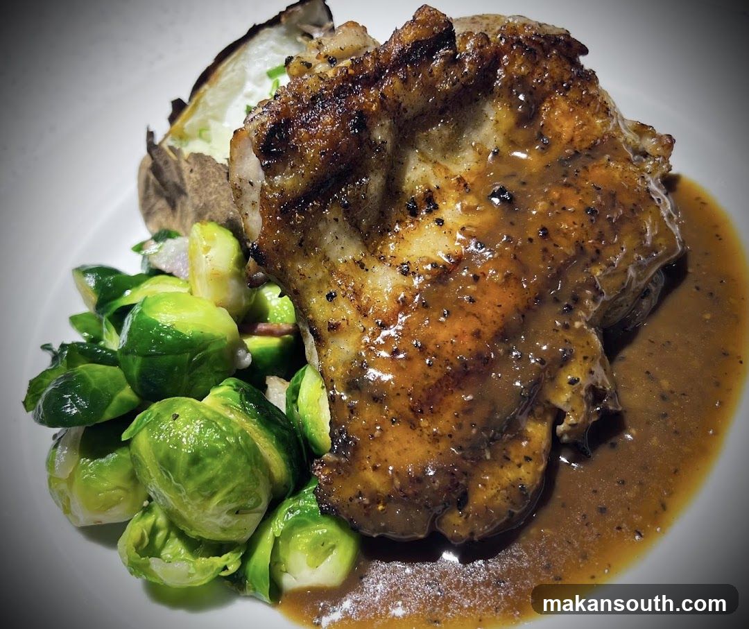 Sauced Pork Chop with Brussels Sprouts and Baked Potato