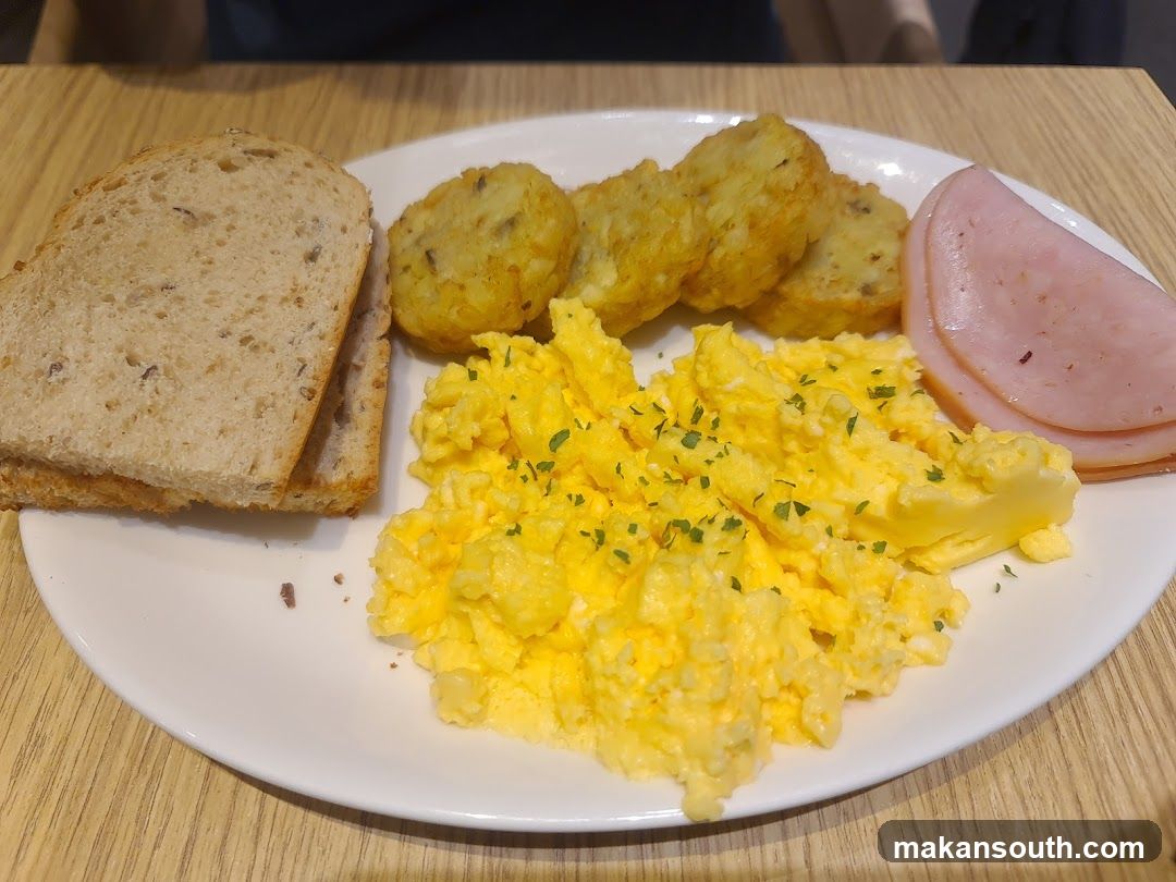 Breakfast Plate with Scrambled Eggs, Ham, Hash Browns and Bread
